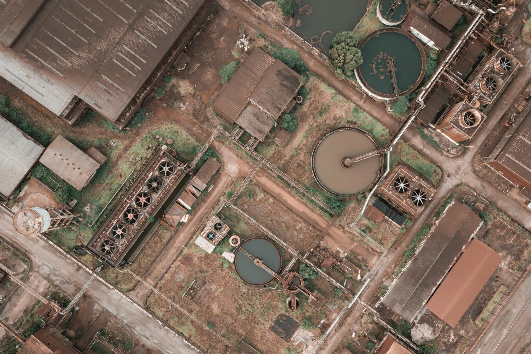 Aerial view of an industrial terminal with circular tanks in the Netherlands